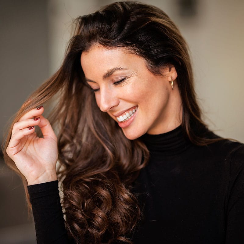 attractive brunette haired woman with toothy smile